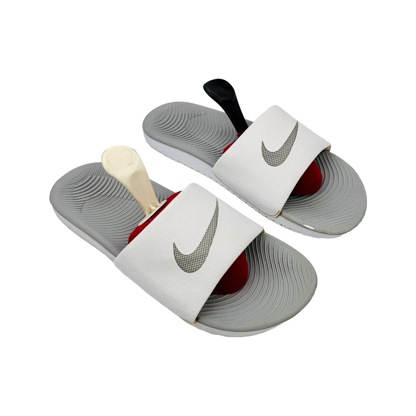 White kawa slides with Nike logo on a white background