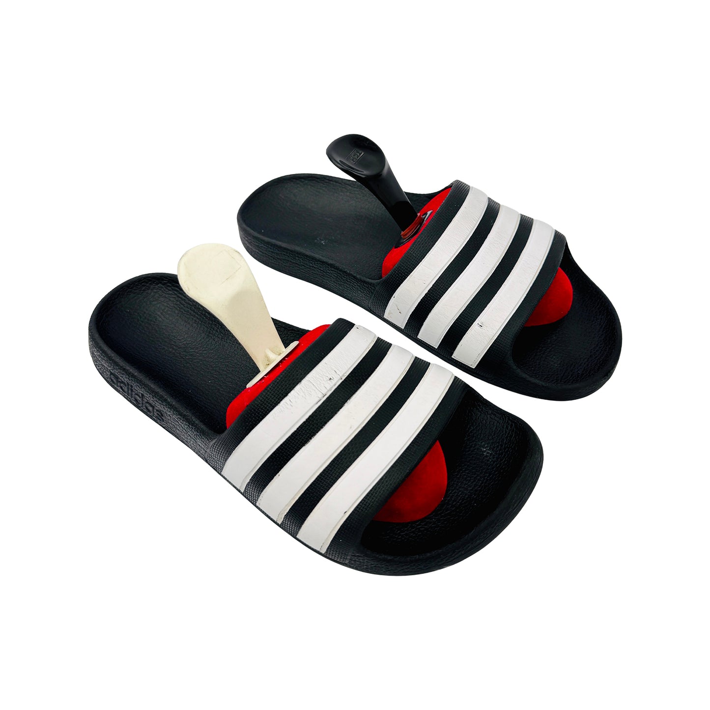 Adidas Adilette Black slides with white stripes and red filling on a white background