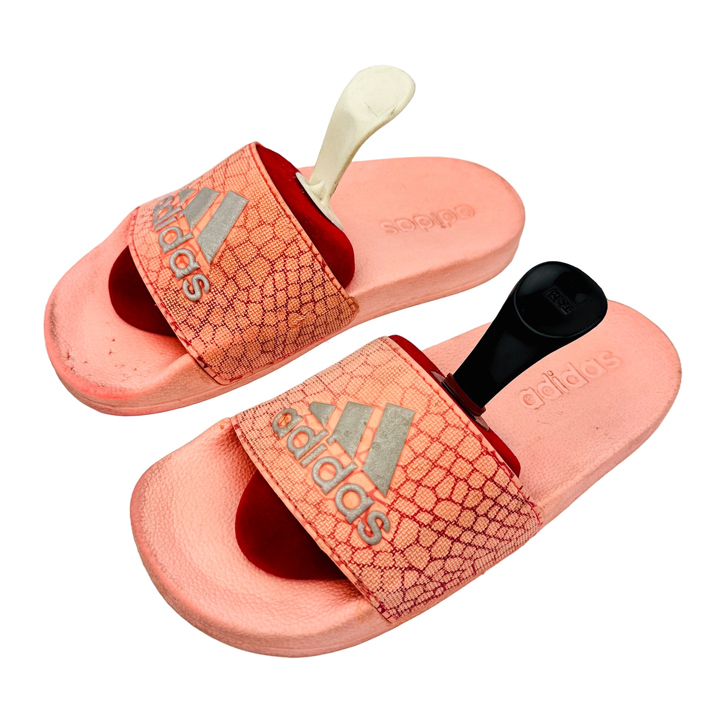 Pink Adidas Adilette slides with design on a white background