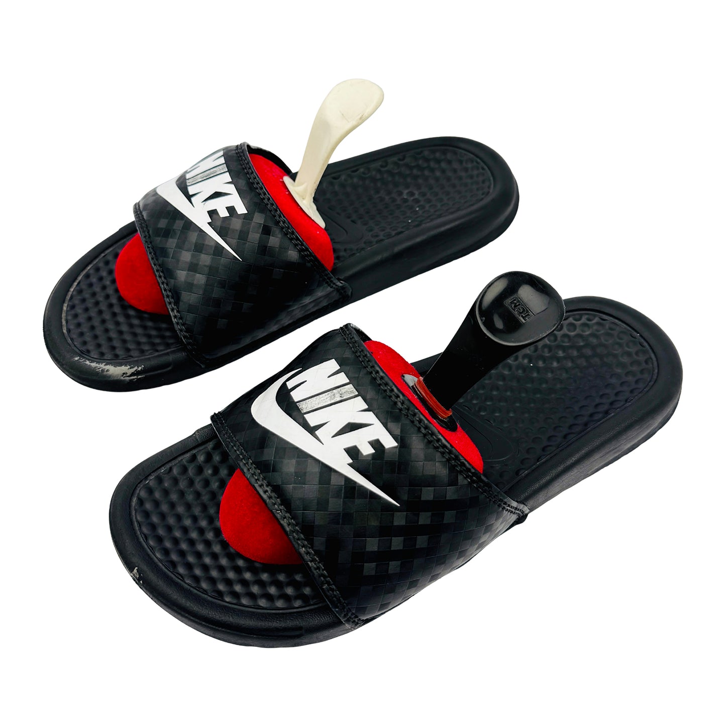 Black Nike Benassi JDI slides with red filling on a white background