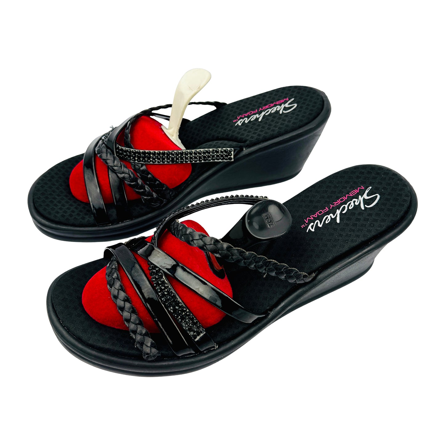 Black Skechers sandals with black straps and a braided design on a white background