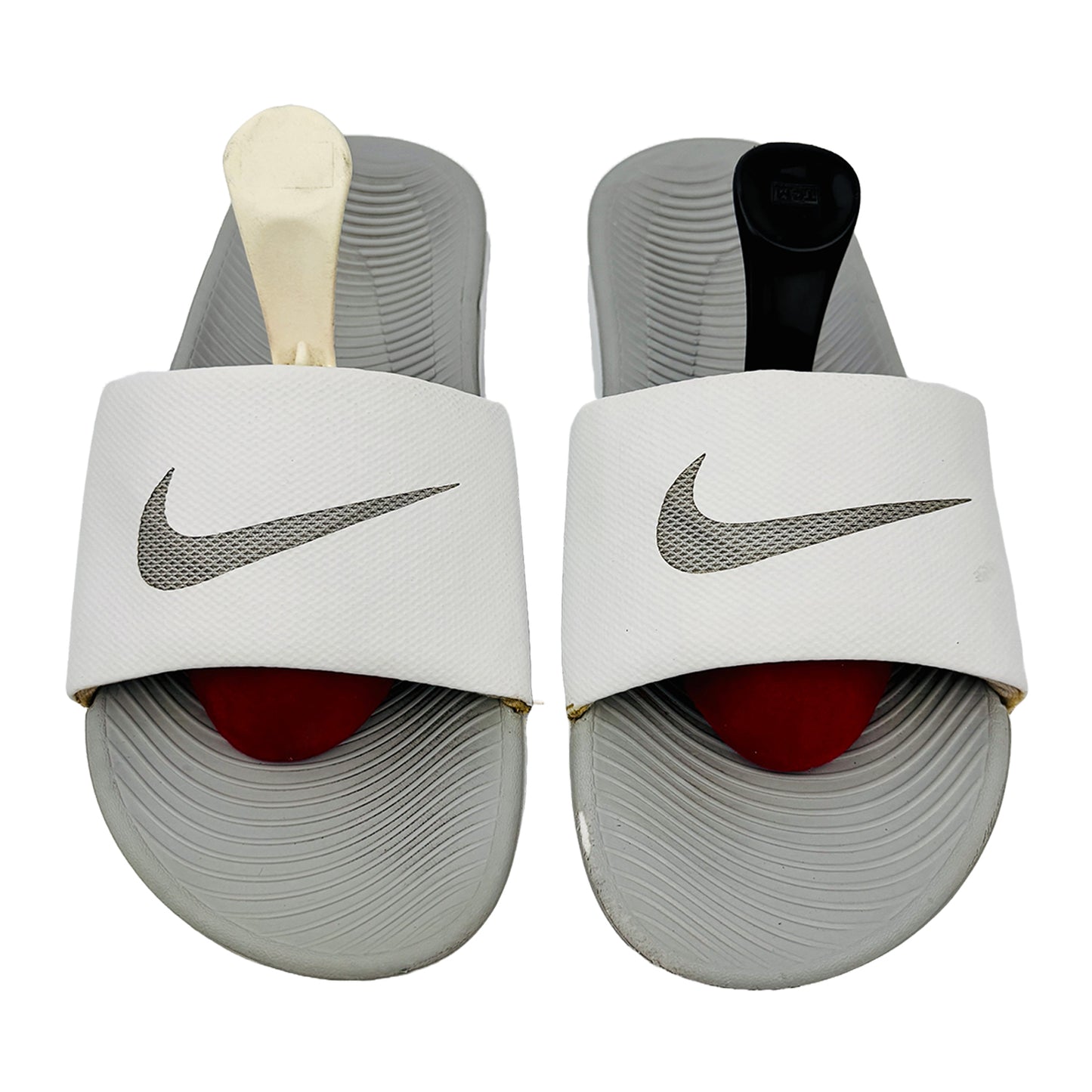 Pair of Nike kawa slides on a white background