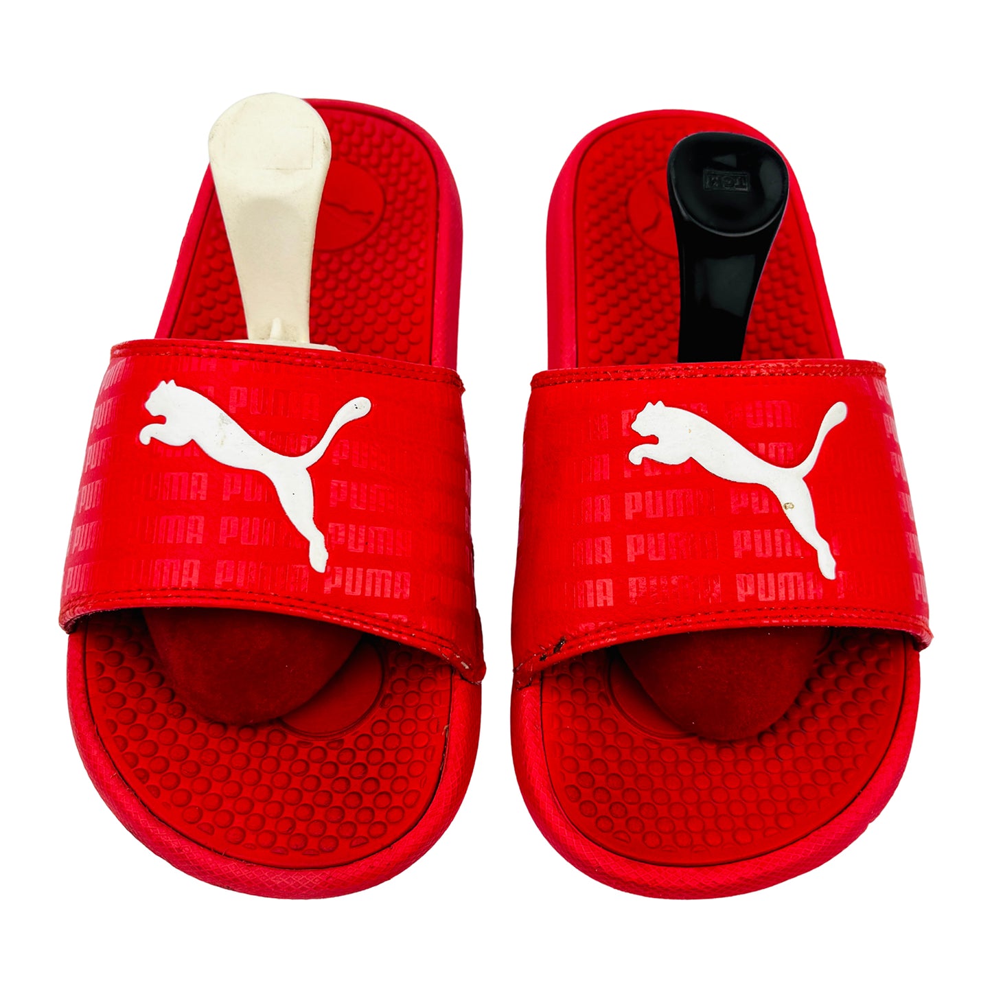 Red Puma slides with white logo on a white background