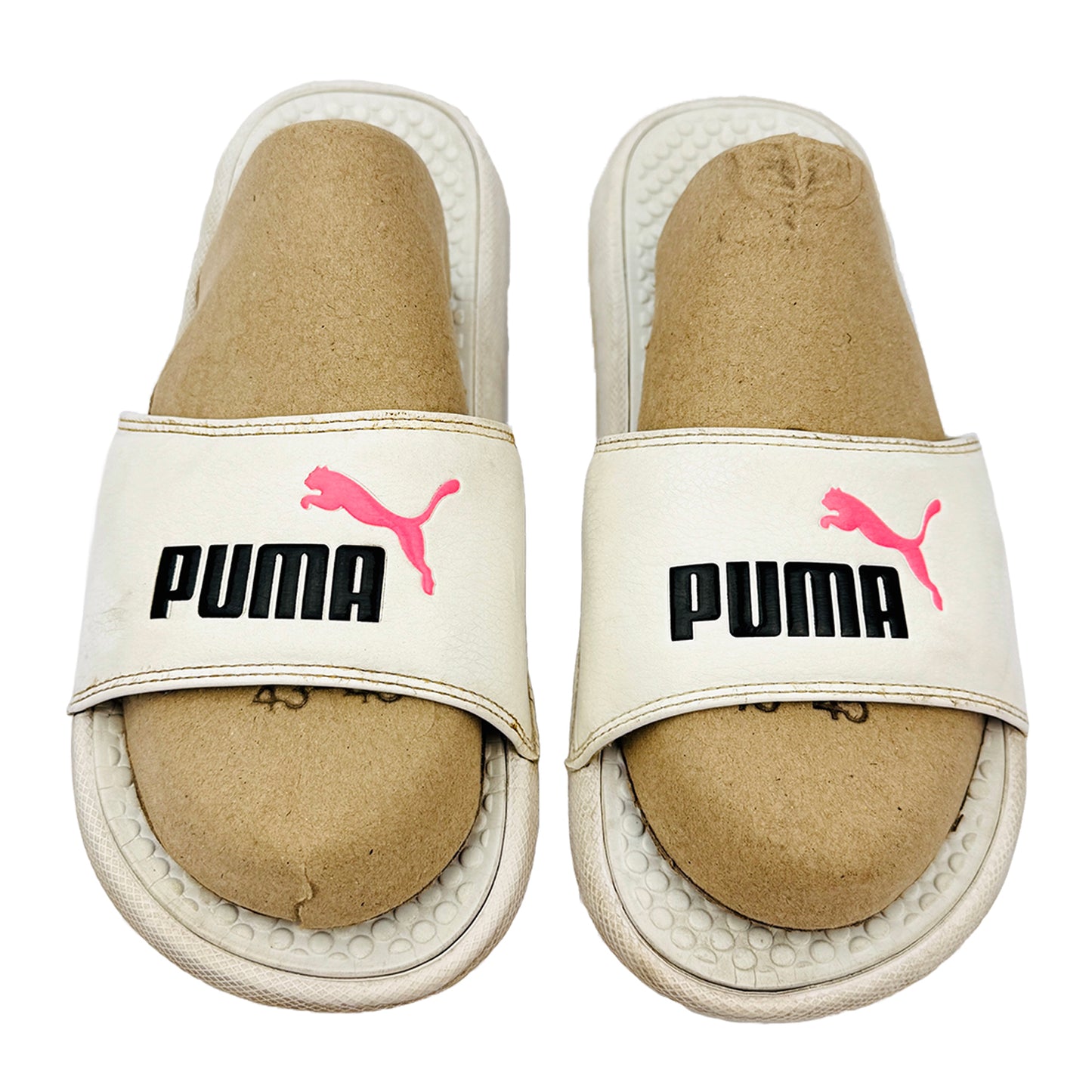 Pair of Puma slides with white soles on a white background