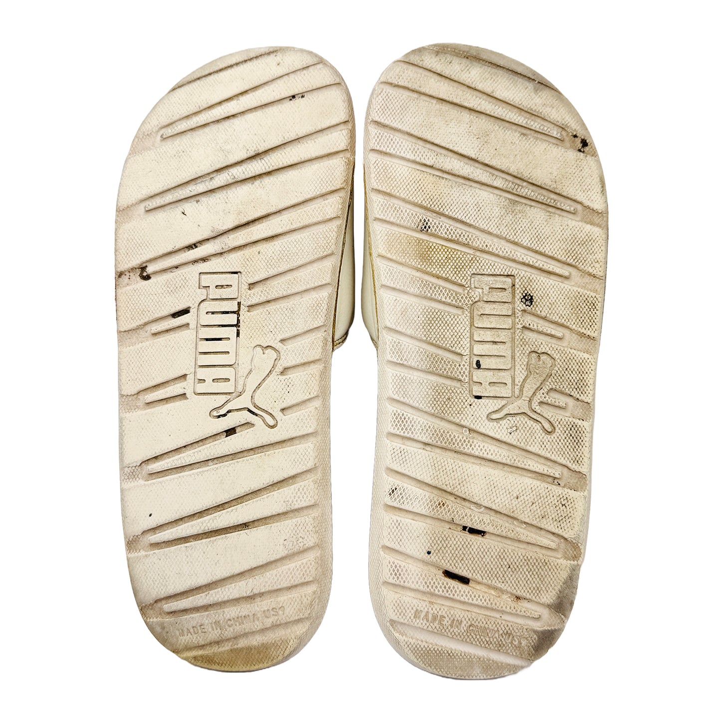 Outsole of Slides with Puma logo on a white background