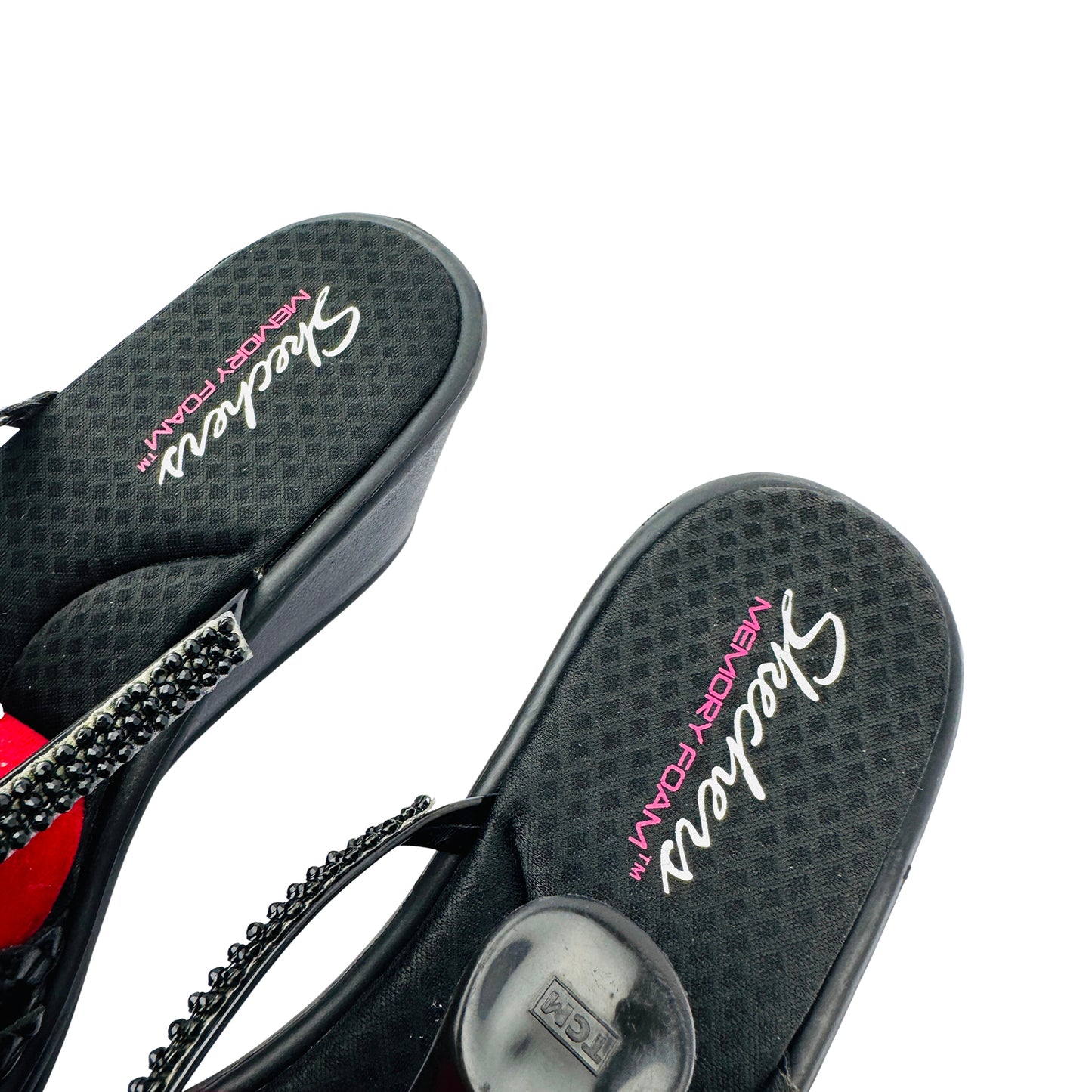 Black Skechers sandals with a chain detail on a white background