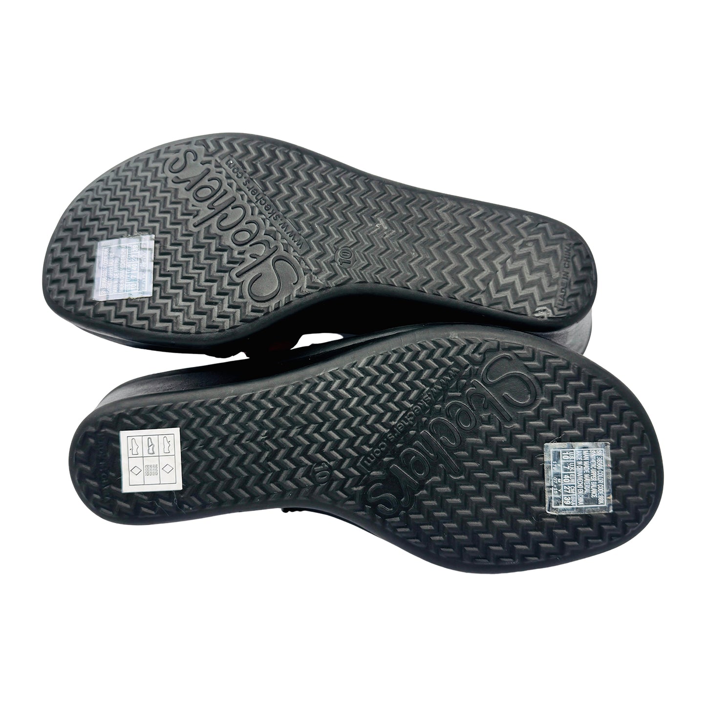Black rubber outsole of a Skechers sandal with brand logo on a white background