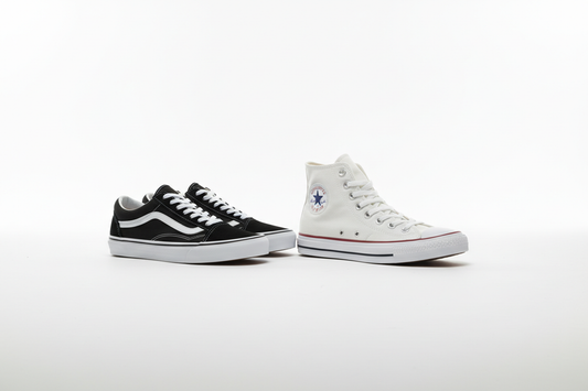  Vans and Converse sneakers placed side by side on a white surface in a clean studio editorial style