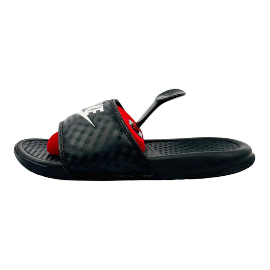 Black Nike Benassi JDI slippers with white accents on a white background