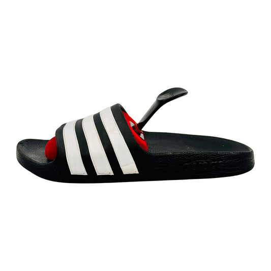 Black adidas adilette slides with white stripes and a white background