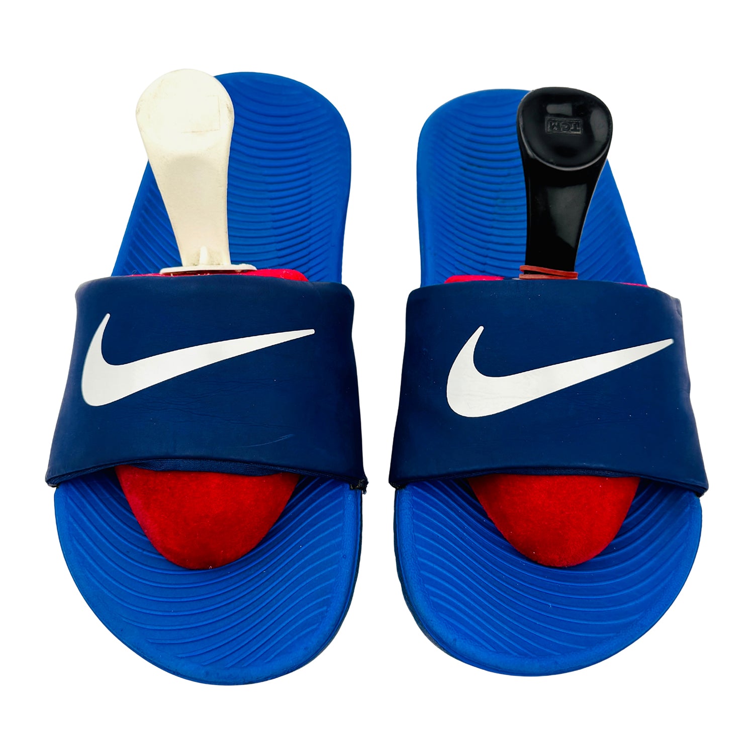 Blue Nike Kawa slides with white swoosh logo on a white background