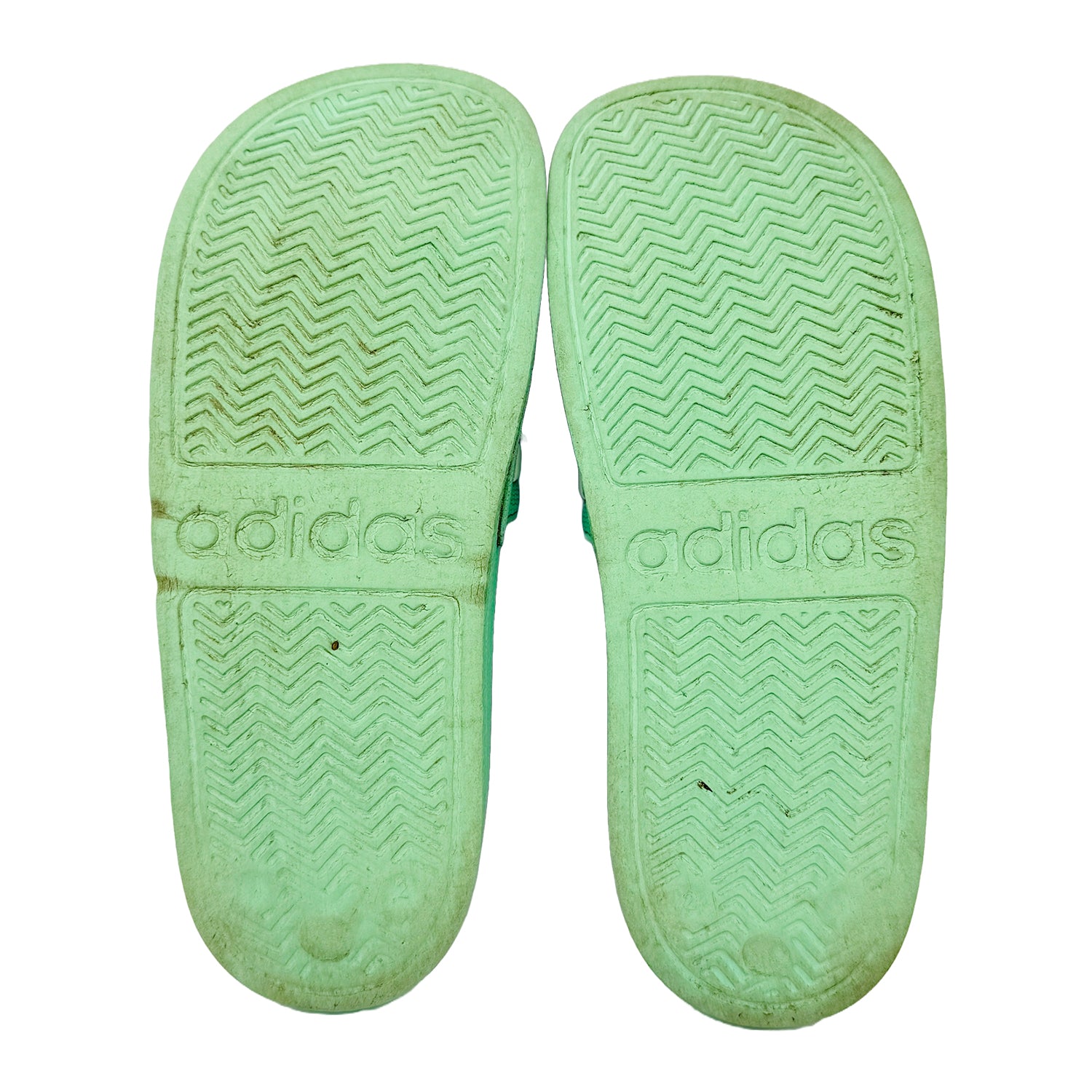 Adidas Adilette Shower Green slides with textured Outsole on a white background