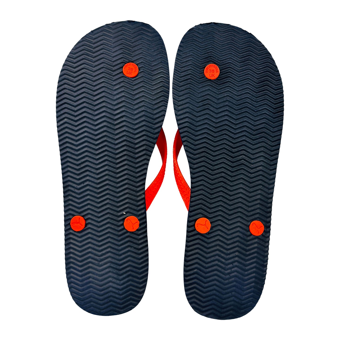 Pair of puma flip-flops showing the outsole on a white background