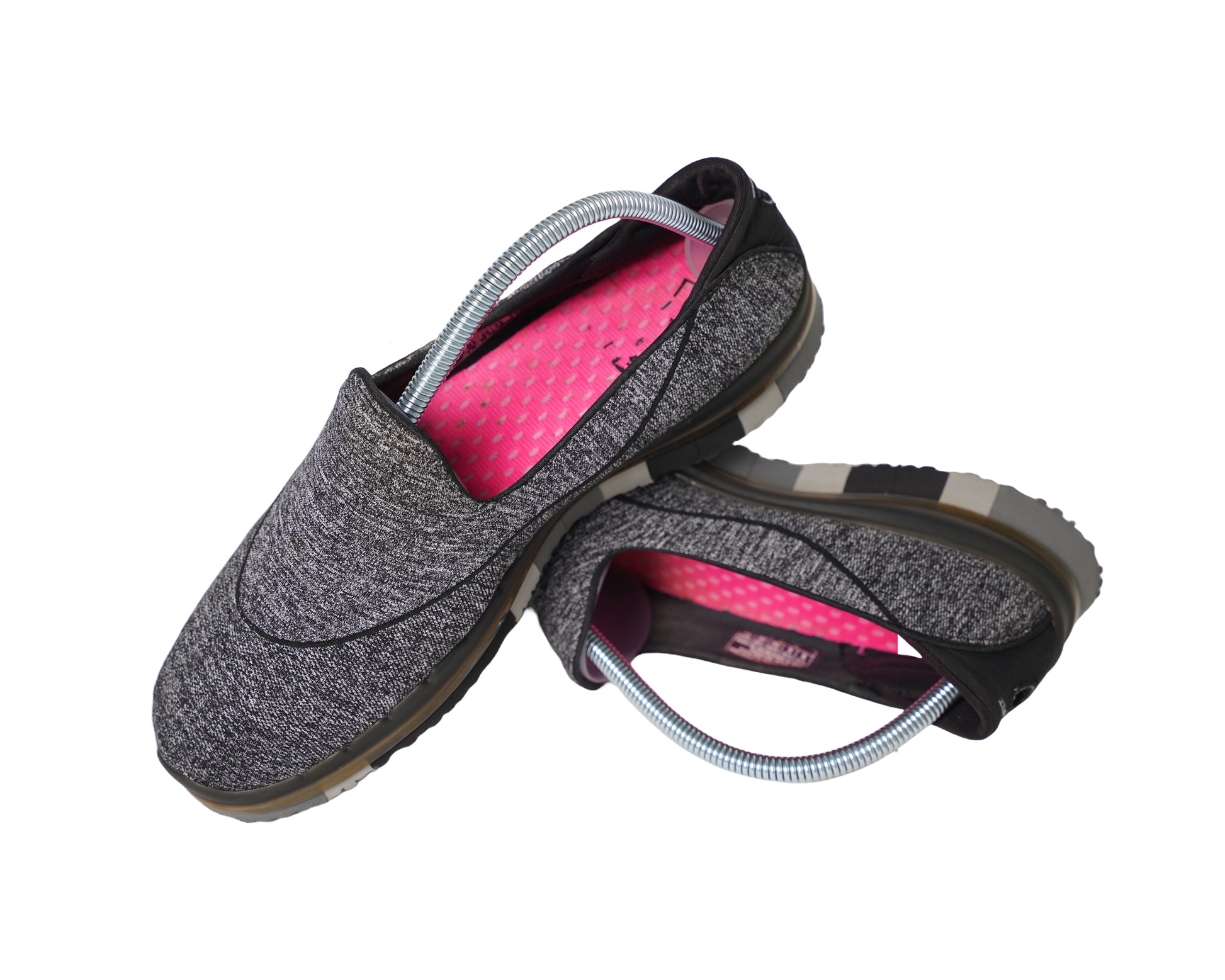 Spring stretcher shoe trees placed inside Skechers pair of shoes